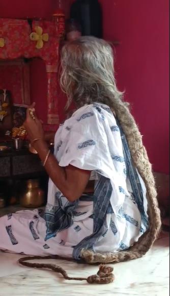 The midwife engaged in the worship of Goddess Manasa
